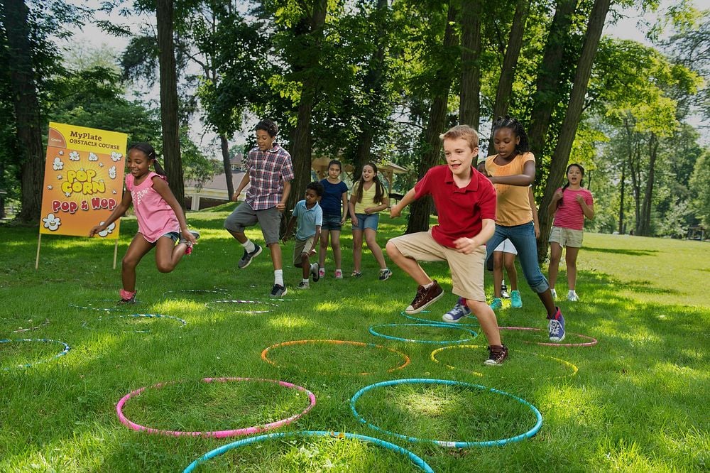 Children Playing Popcorn Pop & Hop in a MyPlate Obstacle Course outside. Original Public Domain Image from Flickr